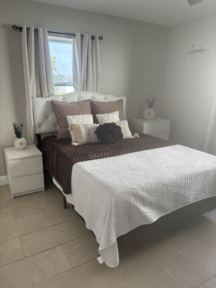Custom tufted upholstered headboard in a Florida bedroom